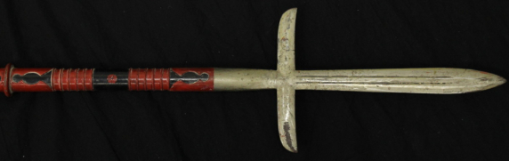 An antique spear with a red and black shaft